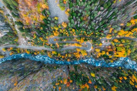 Top view of mountain road in forest with blue river Stock Photos