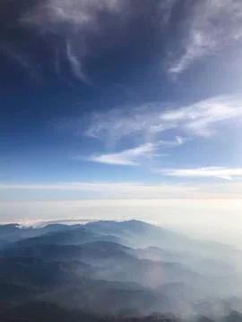 Top view of mountains from the window of plane Stock Photos
