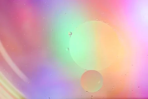 Top view movement of bubbles in the liquid. Oil surface multicolored backgrou Stock Photos
