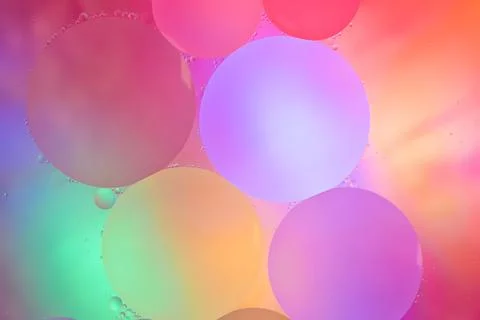 Top view movement of bubbles in the liquid. Oil surface multicolored backgr.. Stock Photos