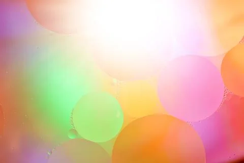 Top view movement of bubbles in the liquid. Oil surface multicolored backgr.. Stock Photos