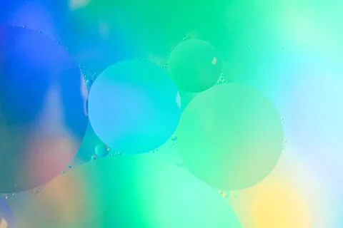 Top view movement of bubbles in the liquid. Oil surface multicolored backgr.. Stock Photos