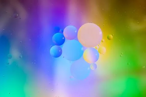 Top view movement of bubbles in the liquid. Oil surface multicolored backgr.. Stock Photos