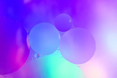 Top view movement of bubbles in the liquid. Oil surface multicolored backgr.. Stock Photos