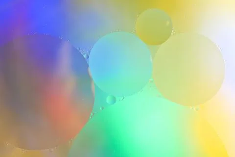 Top view movement of bubbles in the liquid. Oil surface multicolored backgr.. Stock Photos