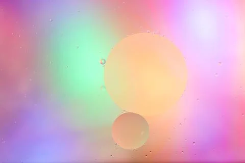 Top view movement of bubbles in the liquid. Oil surface multicolored backgr.. Stock Photos