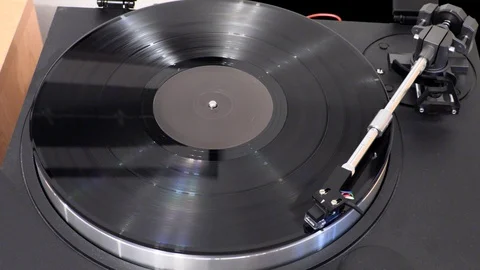 Top view of moving arm of turntable with spinning vinyl record Stock Footage 121168427