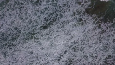 Top view moving down ocean waves crash  drone footage Stock Footage 132800466