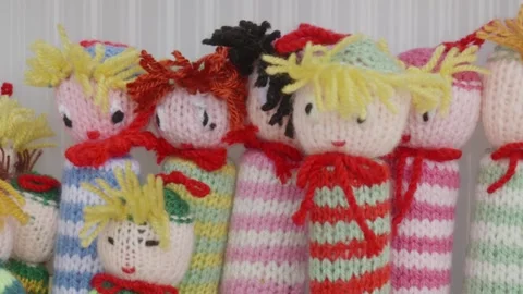 Top View Moving Shot of Wool Figurines from Traditional Knitting Craft Stock Footage 316487060