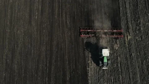 Top view of a moving tractor plowing the ground Stock Footage 157906167