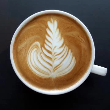Top view of a mug of latte art coffee. Stock Photos