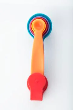 Top View Of Multi Colored Measuring Spoons Isolated on White Background Stock Photos