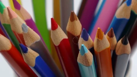 Top view on multi colored pencils rotating in white background.  Video stock 122127565