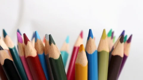 Top view on multi colored pencils rotating in white background.  Video stock 124661880