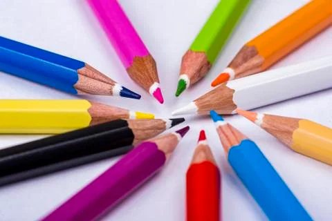 Top view on multi colored pencils rotating on white background. Close-up view Stock Photos