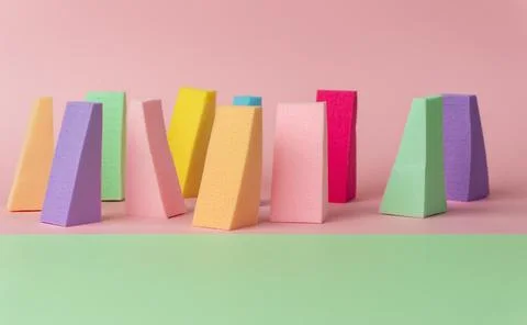 Top view of multi-colored sponges on different pastel-colored backgrounds. Ab Fotos Stock