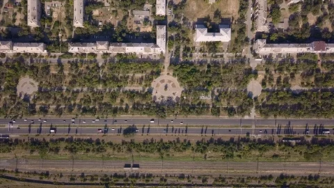 Top view of multi-lane road with movement of cars,railway,park,summer sunny day Stock Footage 113093663