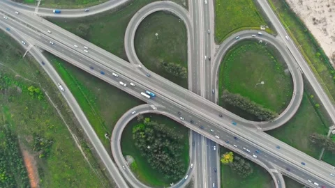Top view of a multi-level bypass road on the highway along which cars move in Stock Footage 209512937