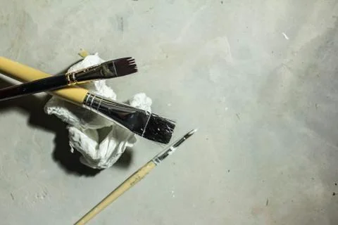 Top view of multi-size paint brushes on cement background Stock Photos