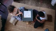 Top View Of Multiracial Couple Sitting On Floor And Playing Board Game. Woman Stock Footage