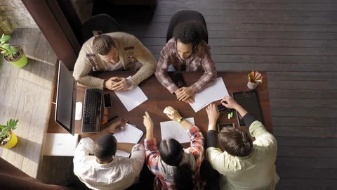 Top view of multiracial creative team of young startupers at work Video stock 126246255