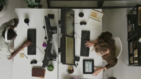 Top View of Multiracial Programmers Coding on Computers in Office Stock Footage 255782198