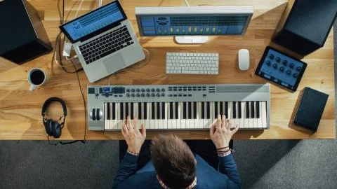 Top View of a Musician Creating Music at His Studio, Playing on a Musical Key Stock Photos