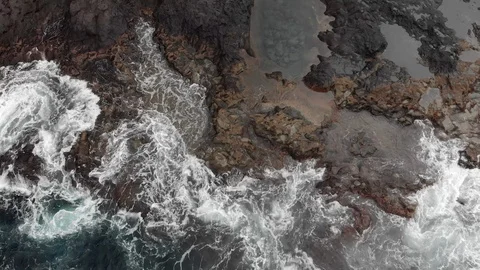 Top view. Natural pools, steep volcanic shore, reefs of frozen volcanic lava Stock Footage 104111859