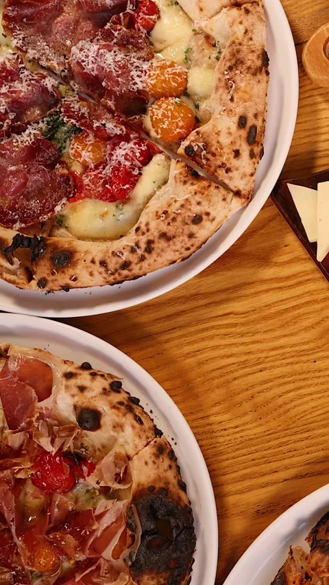 Top View of Neapolitan Pizza and Italian Antipasto on Wooden Table Stock Footage 339841563