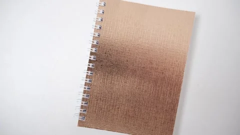Top view of a new golden glitter cover notebook on a white background. Educ.. Stock Footage 342472998