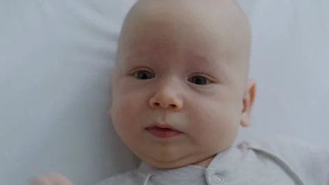 Top view, newborn baby lying in bed. Motherhood Stock Footage 305999828