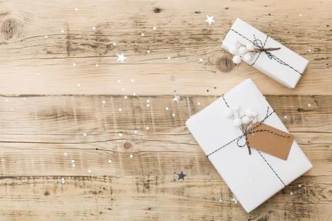 Top view on nice Christmas gift wrapped in white gift paper on background Stock Photos