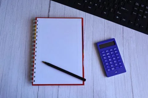 Top view of note pad, pen, and calculator on a desk Stock Photos