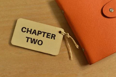 Top view of notebook and label tag written with CHAPTER TWO Stock Photos