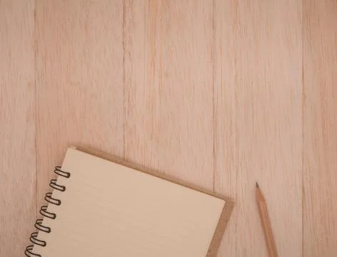 Top view notebook and pencil on wood plank,wooden background Stock Photos