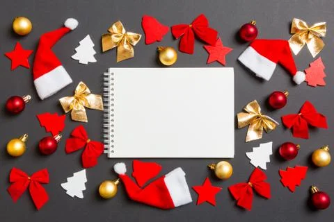 Top view of notebook on black background with New Year toys and decorations.  Stock Photos