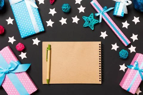 Top view of notebook on black background made of Christmas decorations. New.. Stock Photos