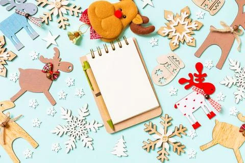 Top view of notebook on blue background made of holiday decorations and toy.. Stock Photos
