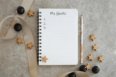 Top view of notebook with Christmas decorations. Goals list for new year. Fre Stock Photos