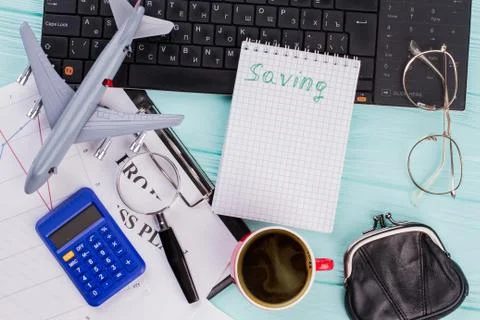 Top view of notebook cup coffee plane and eye glasses on table. Stock Photos