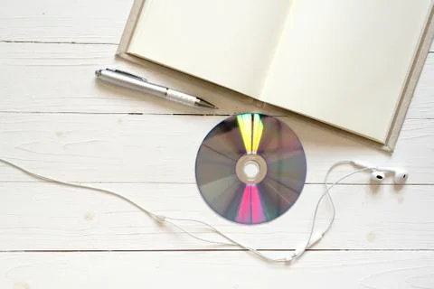 Top view of notebook dvd disc and earphone Stock Photos
