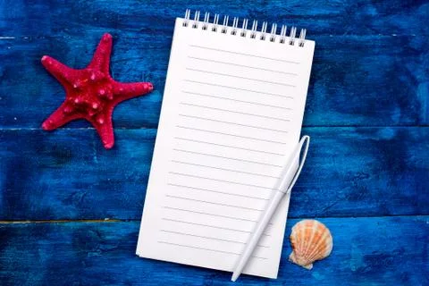 Top view notebook with empty sheet, pen and sea shells Stock Photos