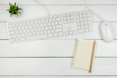 Top view of a notebook  with keyboard and mouse on white office desk Stock Photos