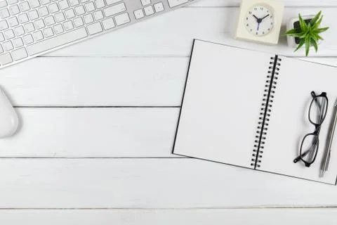 Top view of notebook on the minimal office desk Stock Photos