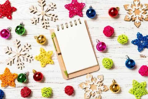 Top view of notebook on wooden background made of Christmas decorations. Ne.. Stock Photos