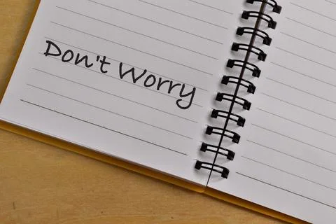 Top view of notebook written with DON'T WORRY. Stock Photos