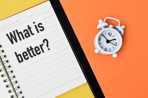 Top view of notebook written with question WHAT IS BETTER? Stock Photos