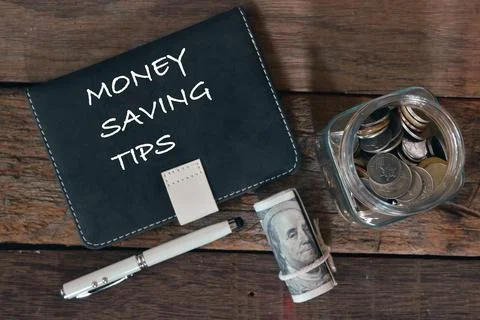 Top view of notebook written with text MONEY SAVING TIPS. Stock Photos