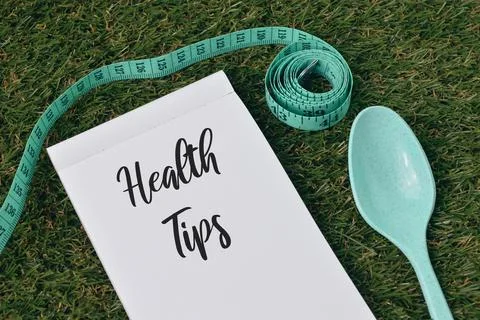 Top view of notebook written with text HEALTH TIPS. Stock Photos