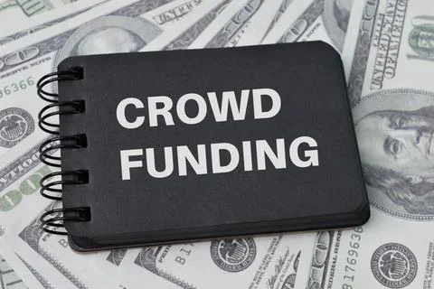 Top view of notebook written with text CROWDFUNDING. Stock Photos